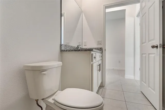 a white toilet sitting next to a bathroom sink