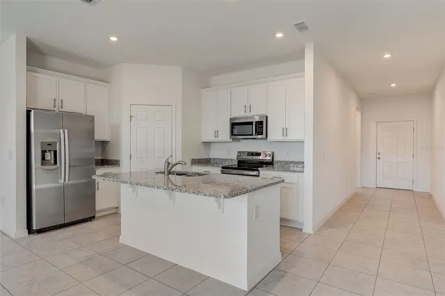 a kitchen with cabinets and stainless steel appliances