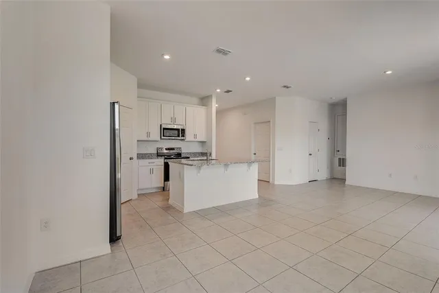 a kitchen with cabinets and stainless steel appliances