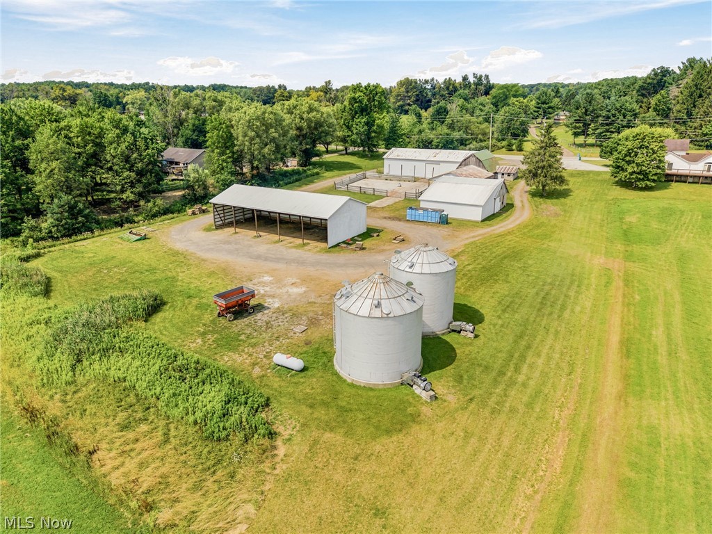 11513 Kile Road Chardon, OH 44024 - Photo 29 of 48 Expansive agricultural property featuring multiple outbuildings, two large grain bins, and a covered open-sided pole barn
