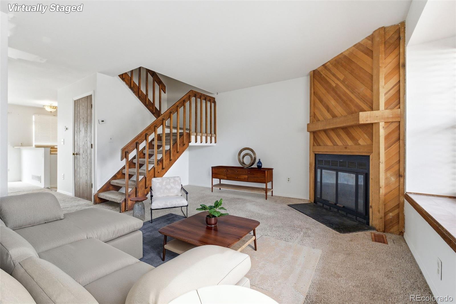 17335 East Rice Circle, Unit C Aurora, CO 80015 - Photo 2 of 14 a living room with furniture and a fireplace