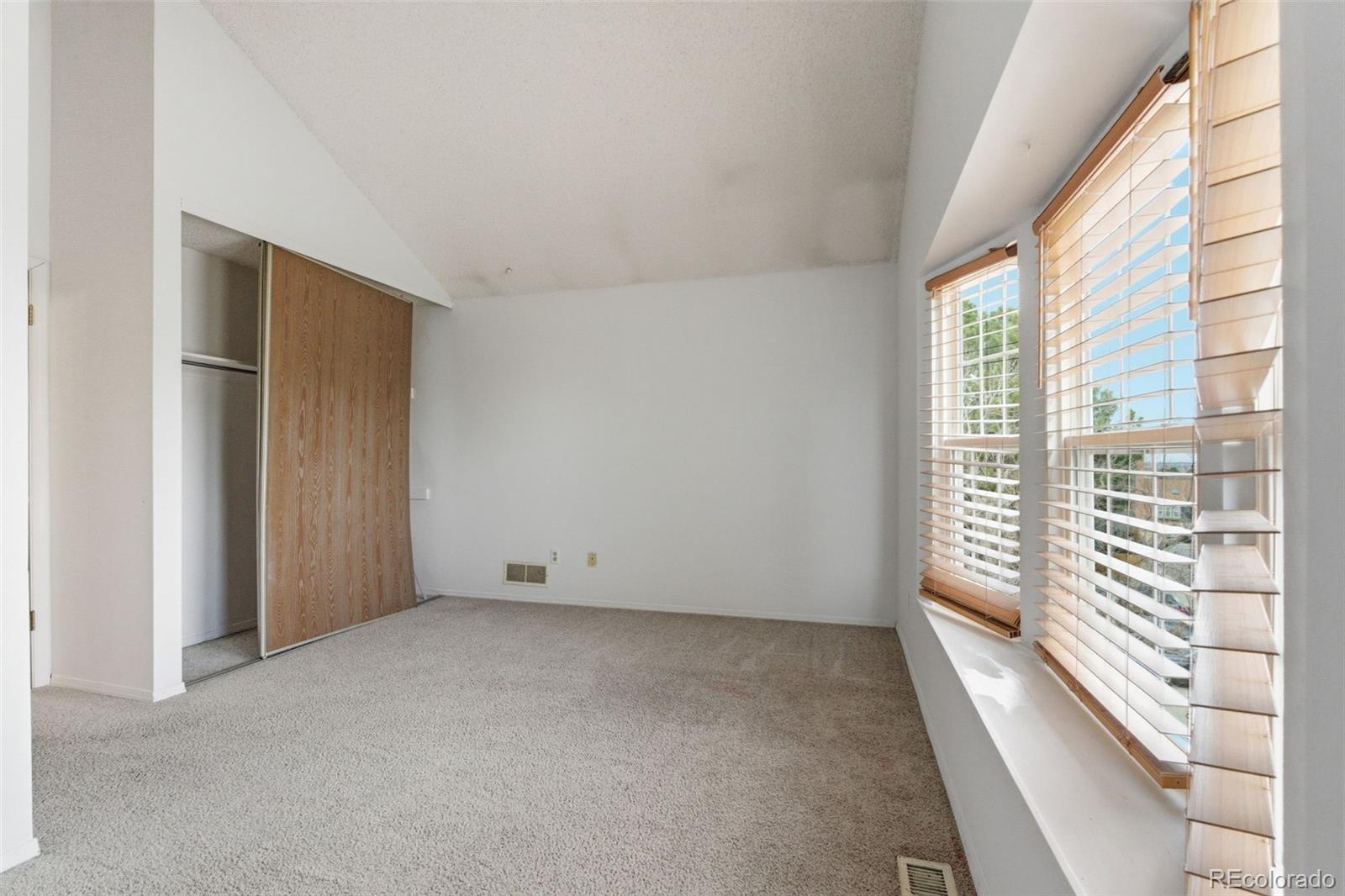 17335 East Rice Circle, Unit C Aurora, CO 80015 - Photo 7 of 14 a view of an empty room with a window