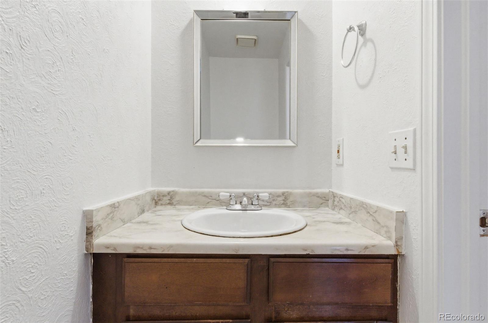 17335 East Rice Circle, Unit C Aurora, CO 80015 - Photo 10 of 14 a sink and a mirror
