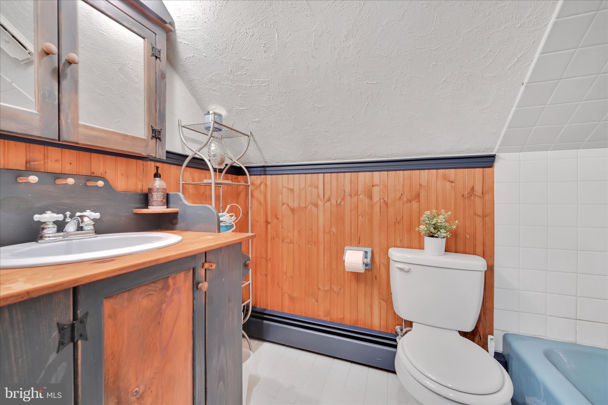 85 Gernants Church Road Leesport, PA 19533 - Photo 19 of 43 a bathroom with a sink a toilet a mirror and shower curtain