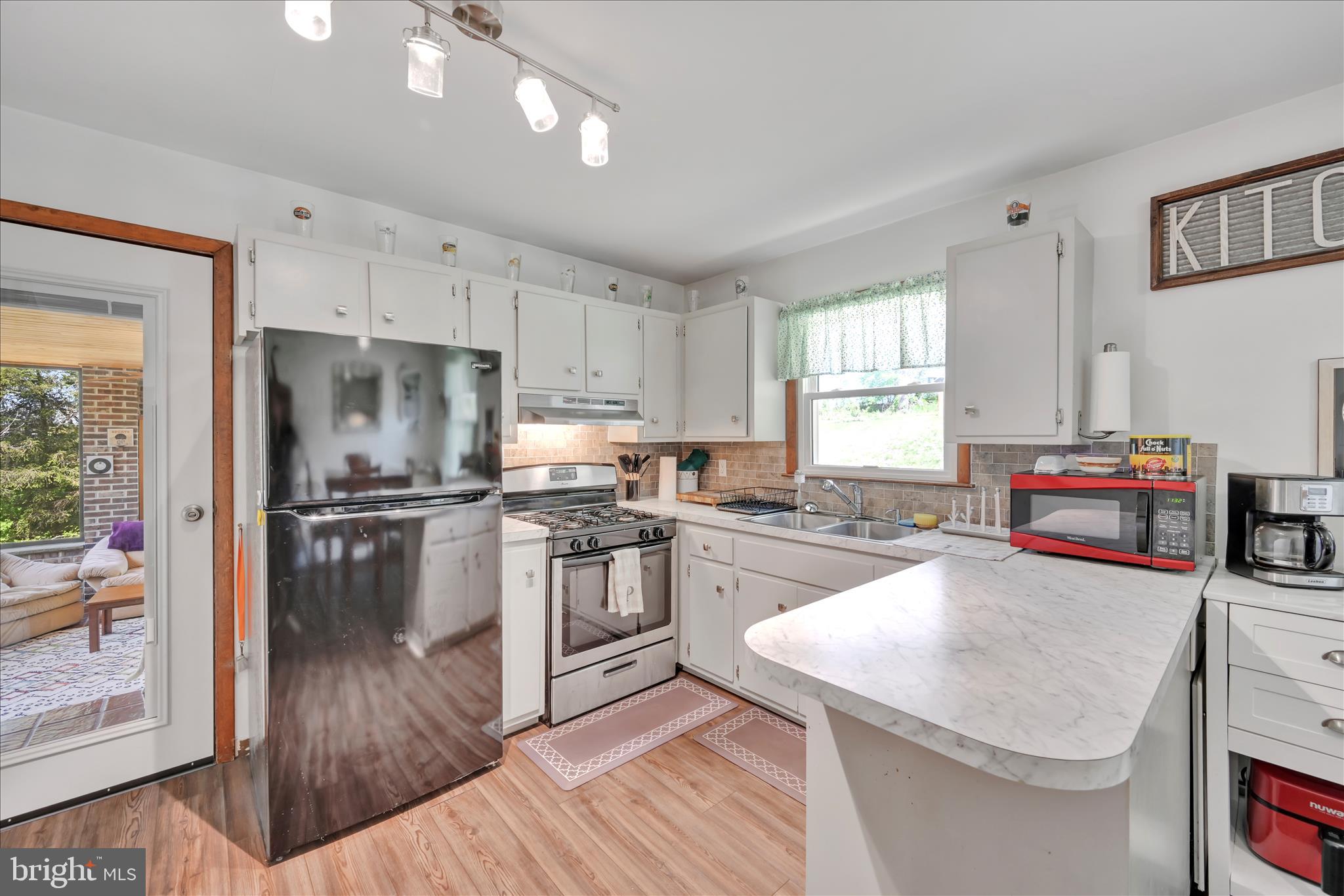 85 Gernants Church Road Leesport, PA 19533 - Photo 6 of 43 a kitchen with granite countertop a sink stove and refrigerator