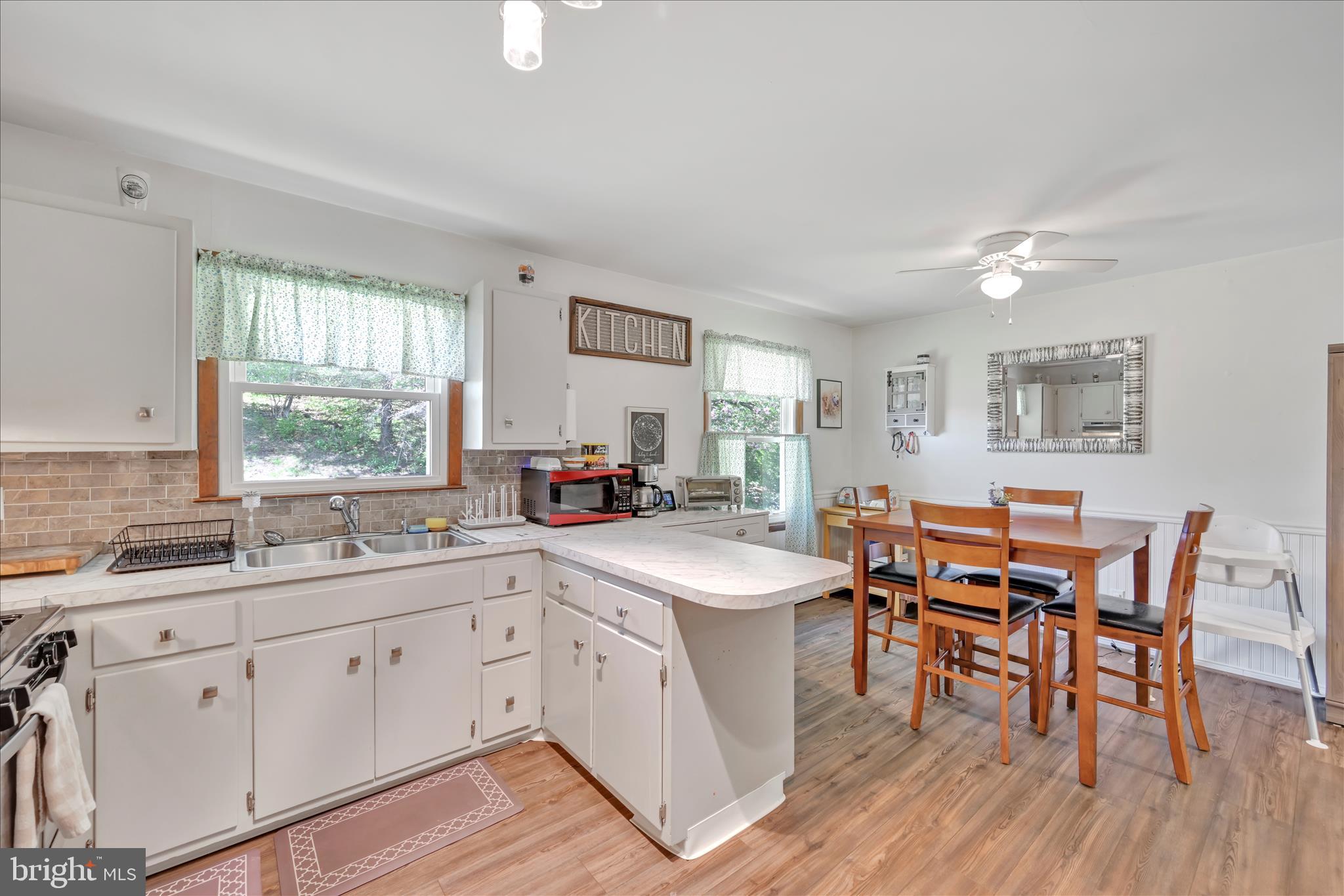 85 Gernants Church Road Leesport, PA 19533 - Photo 8 of 43 a kitchen with a sink stove and white cabinets with wooden floor