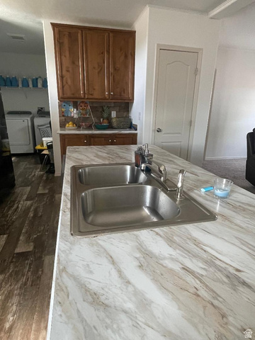 289 West Center Street Hinckley, UT 84635 - Photo 6 of 13 Kitchen island featuring a double basin stainless steel sink with a chrome faucet