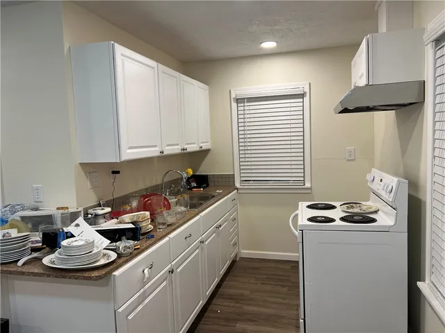 a kitchen with stainless steel appliances kitchen island granite countertop a sink and cabinets