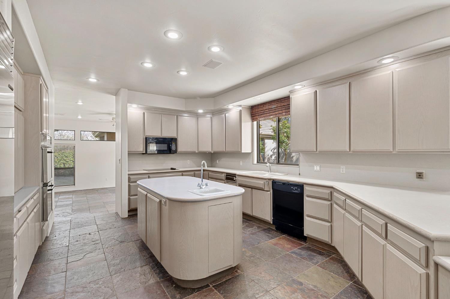 5724 Parker Road Modesto, CA 95357 - Photo 14 of 69 a large kitchen with kitchen island a sink stainless steel appliances and cabinets