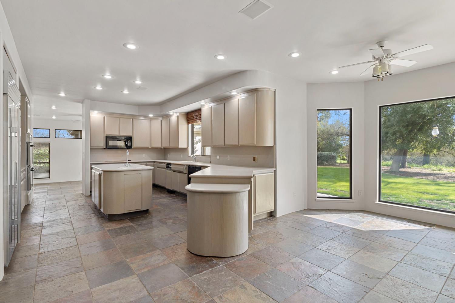 5724 Parker Road Modesto, CA 95357 - Photo 2 of 69 a kitchen with a sink a counter top space stainless steel appliances and cabinets