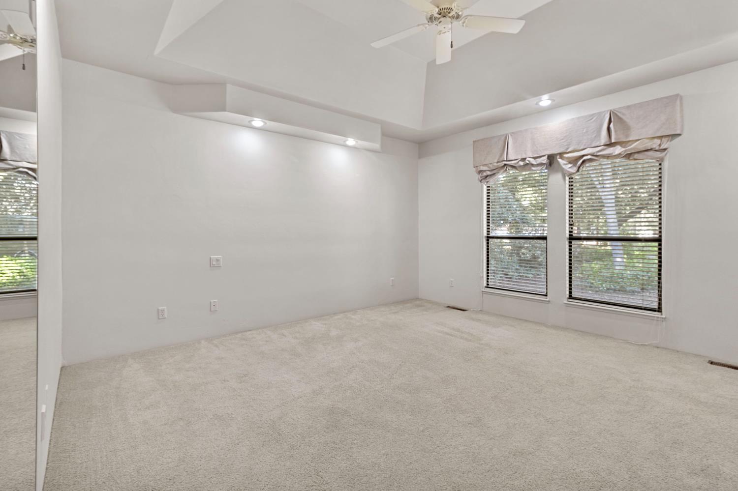 5724 Parker Road Modesto, CA 95357 - Photo 28 of 69 en empty room with windows and chandelier fan