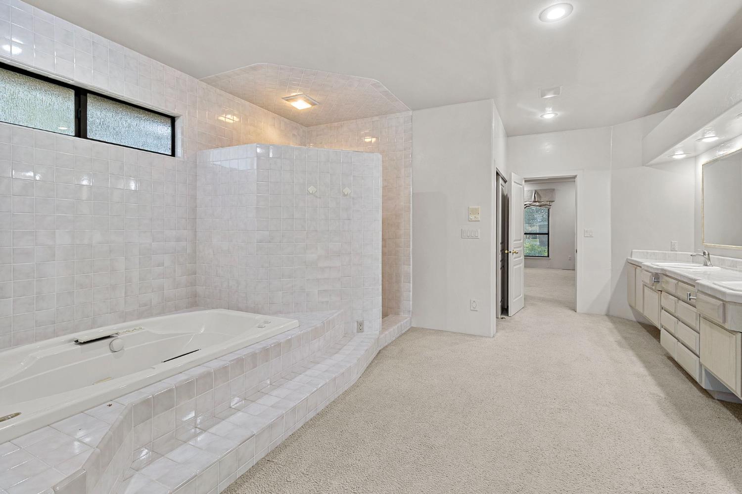 5724 Parker Road Modesto, CA 95357 - Photo 33 of 69 a bathroom with a bathtub and a shower