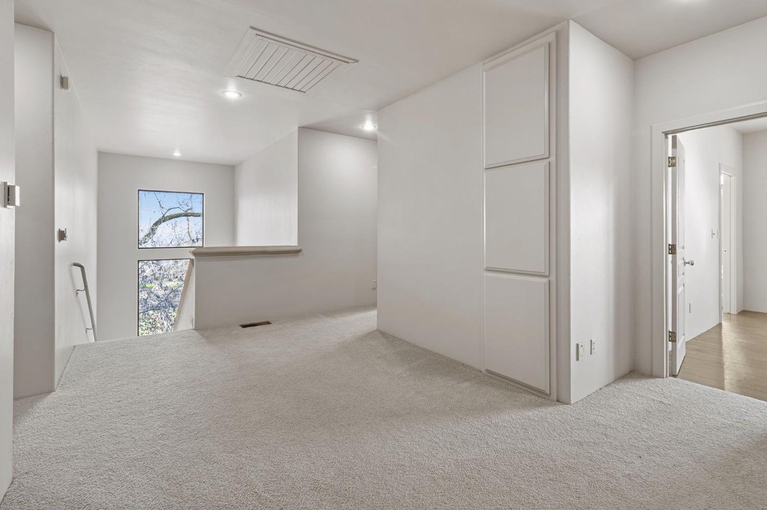 5724 Parker Road Modesto, CA 95357 - Photo 34 of 69 a view of an empty room with window and wooden floor