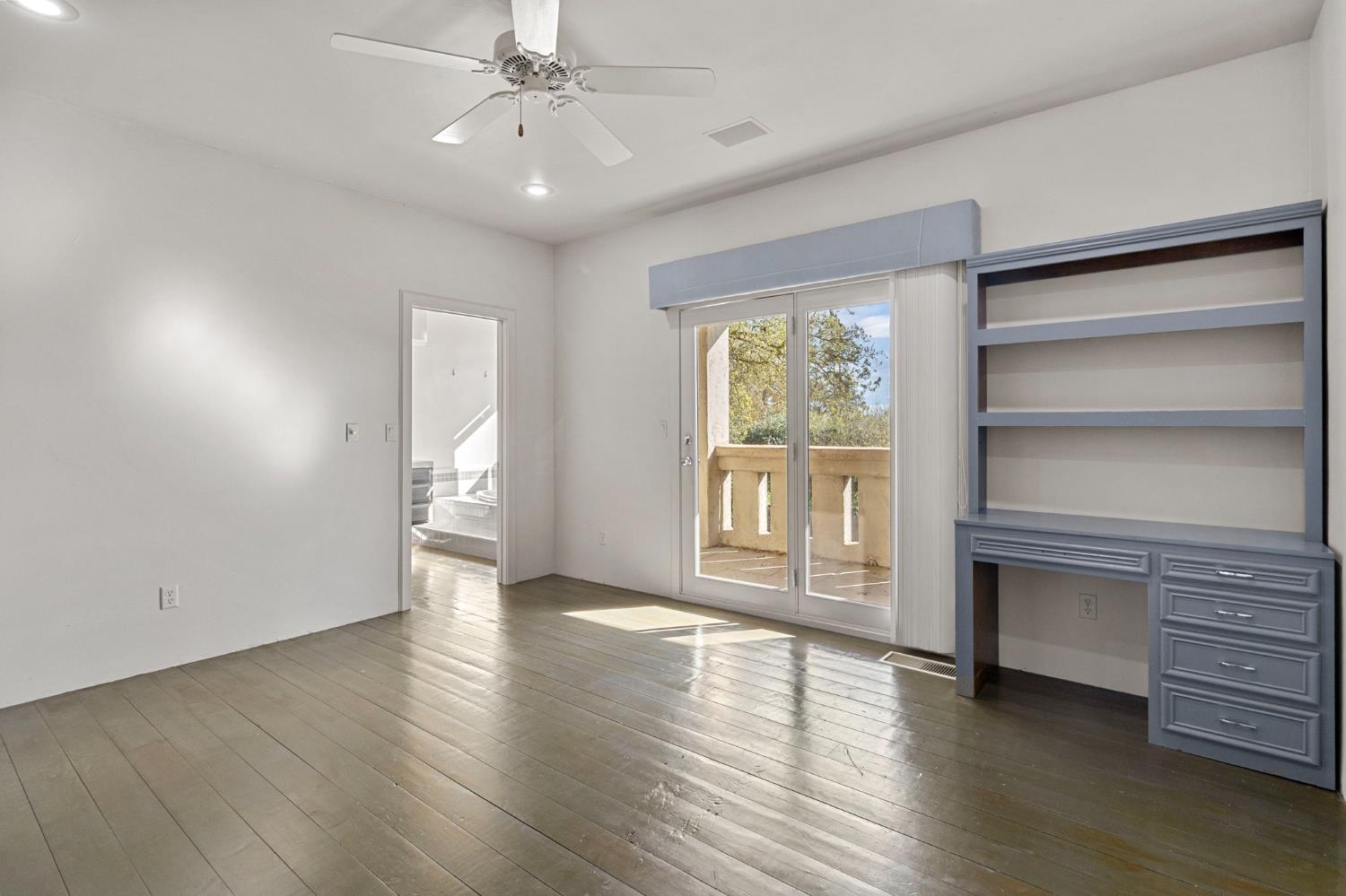 5724 Parker Road Modesto, CA 95357 - Photo 37 of 69 an empty room with wooden floor cabinet and windows