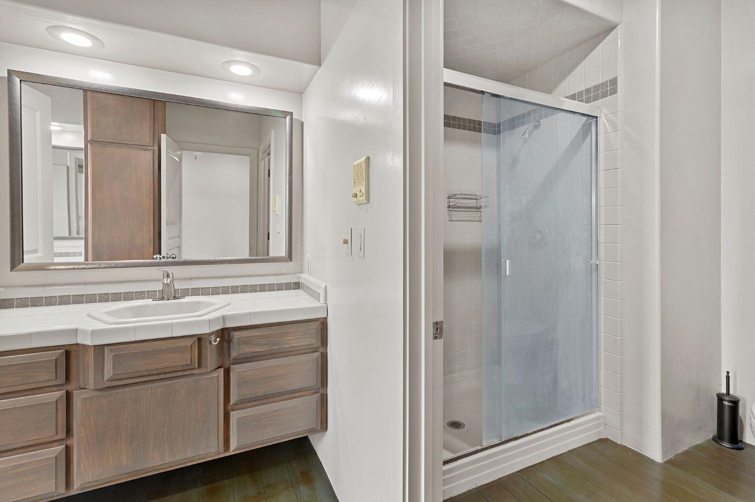 5724 Parker Road Modesto, CA 95357 - Photo 39 of 69 a bathroom with a shower sink and mirror