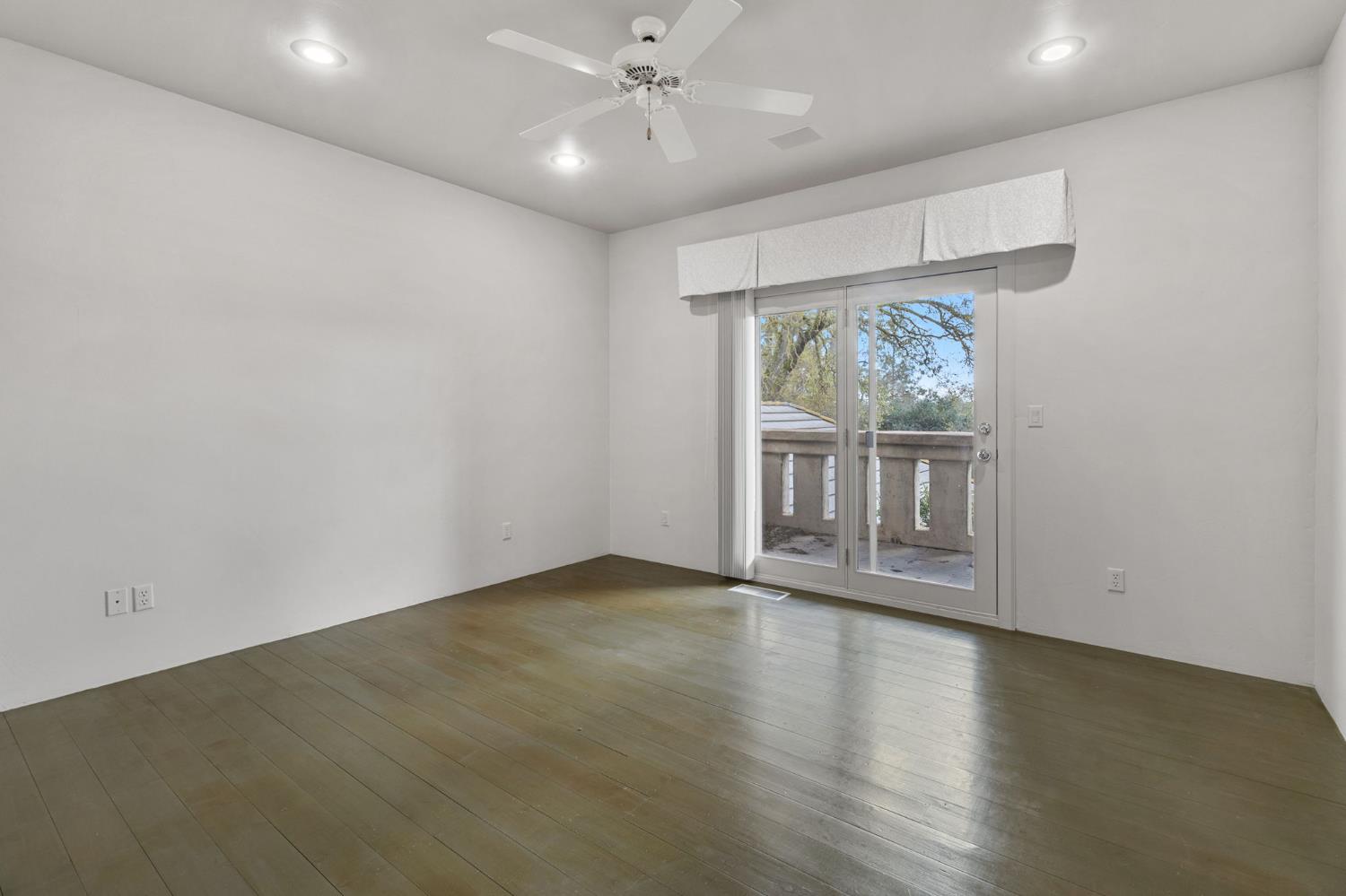 5724 Parker Road Modesto, CA 95357 - Photo 40 of 69 an empty room with wooden floor and windows