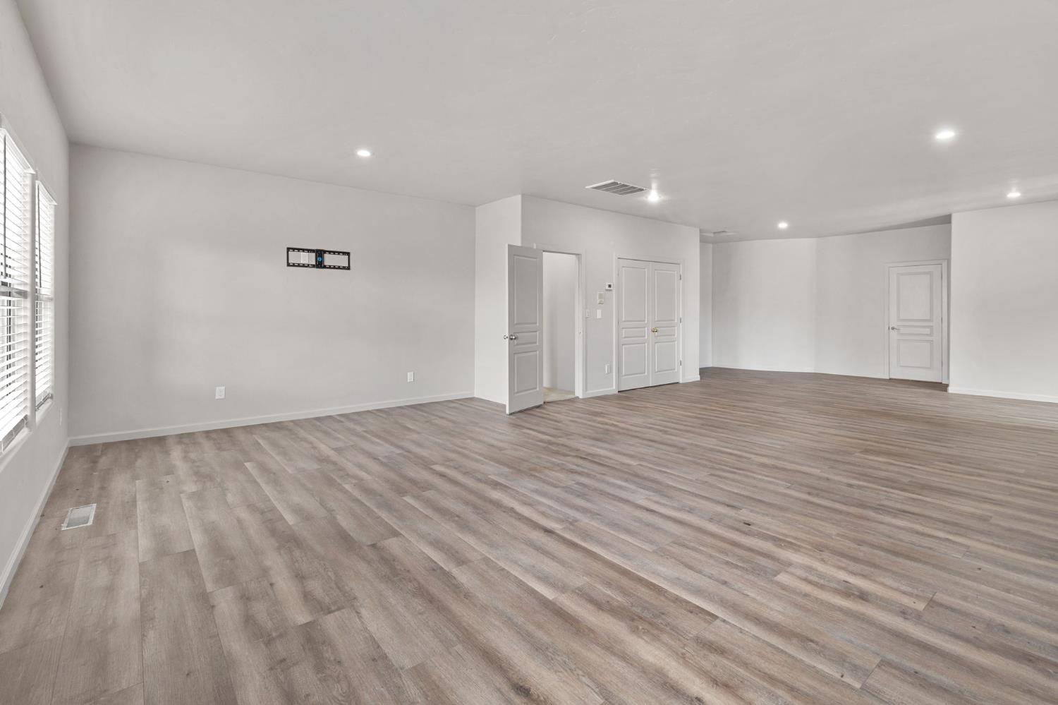 5724 Parker Road Modesto, CA 95357 - Photo 42 of 69 a view of an empty room with wooden floor and a window