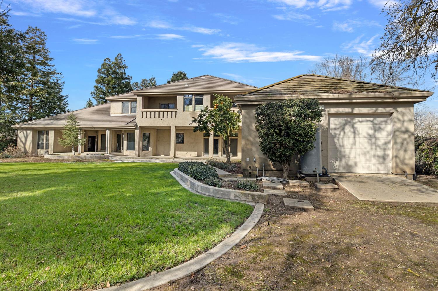 5724 Parker Road Modesto, CA 95357 - Photo 51 of 69 a front view of a house with a garden and porch