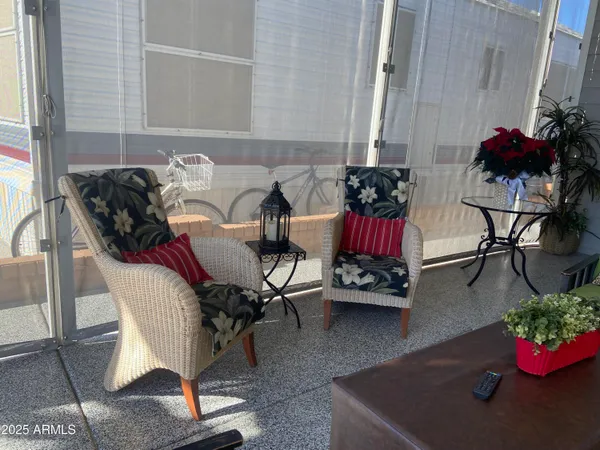 a living room with furniture and flowers