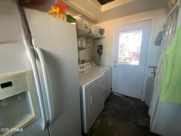 a utility room with cabinets washer and dryer