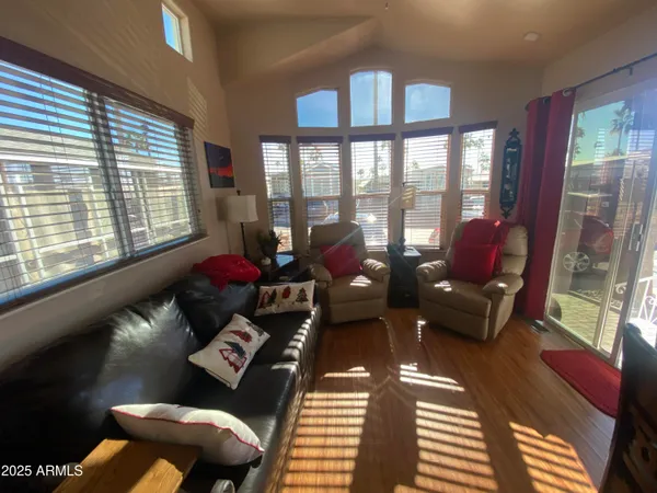 a living room with furniture and a floor to ceiling window