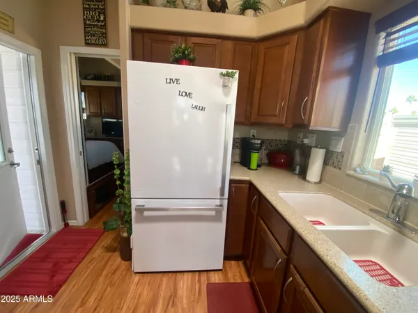 a white refrigerator freezer sitting inside of a kitchen