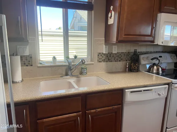 a kitchen with a sink cabinets and window