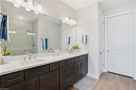 a bathroom with a double vanity sink and a mirror