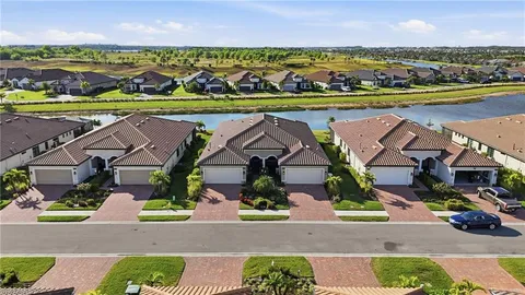 an aerial view of residential houses with outdoor space and lake view