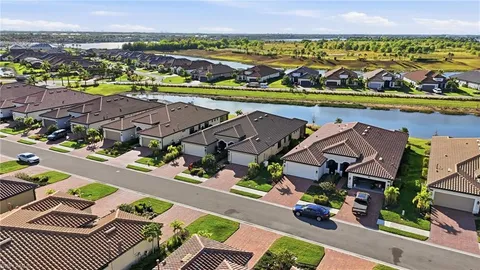 an aerial view of residential houses with outdoor space and street view