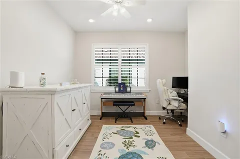 a view of a workspace with furniture and a window