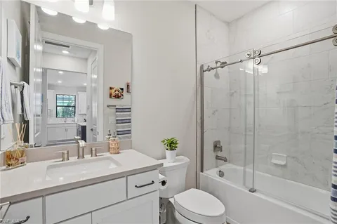 a bathroom with a sink toilet tub and shower