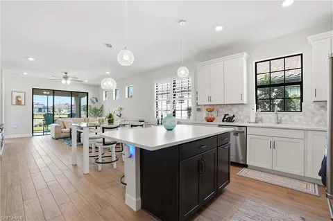 a kitchen with sink cabinets and wooden floor
