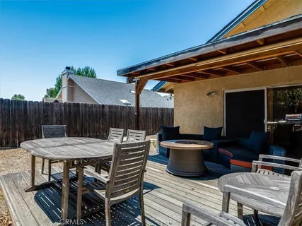 a view of a bench in the backyard with wooden fence
