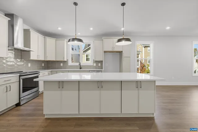 a kitchen with a sink stove and microwave