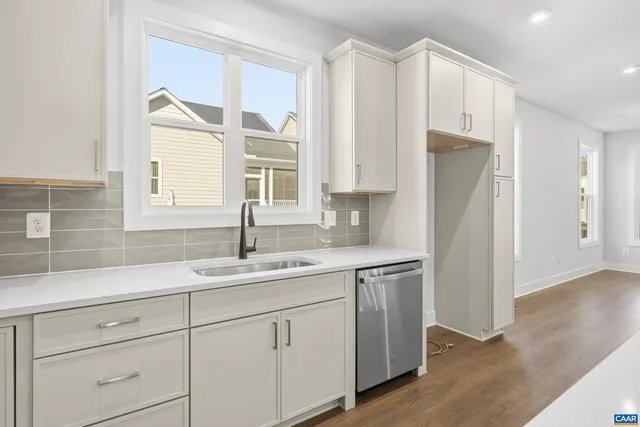 a kitchen with a sink a refrigerator and cabinets