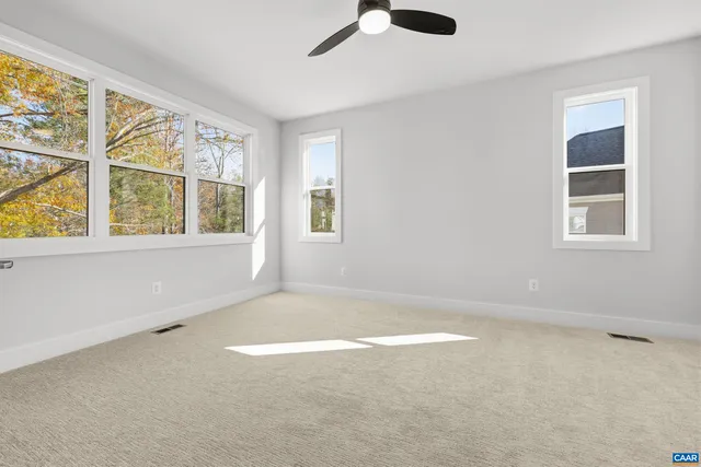 an empty room with a empty space and windows