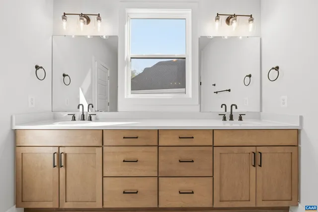 a bathroom with a sink vanity and mirror