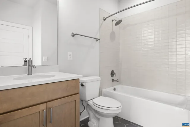a bathroom with a sink toilet vanity and shower