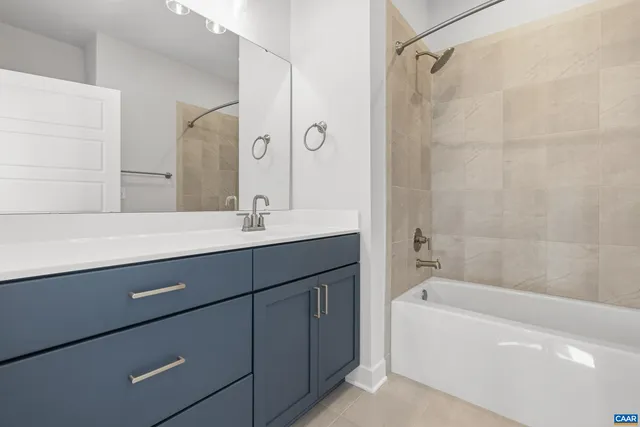 a bathroom with a bathtub sink vanity and mirror