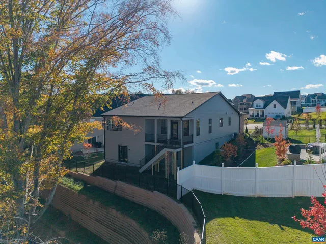 a view of a house with a yard and furniture