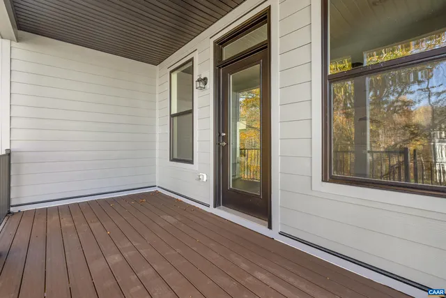 a view of outdoor space with wooden floor and a window