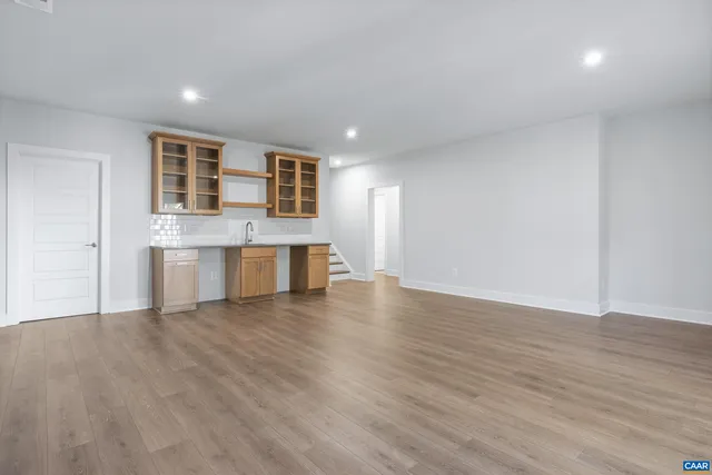 a view of kitchen with wooden floor and electronic appliances