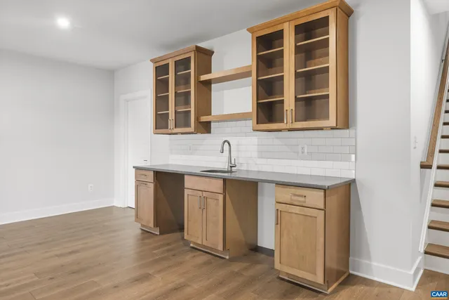 a kitchen with stainless steel appliances granite countertop a sink and dishwasher with wooden floor
