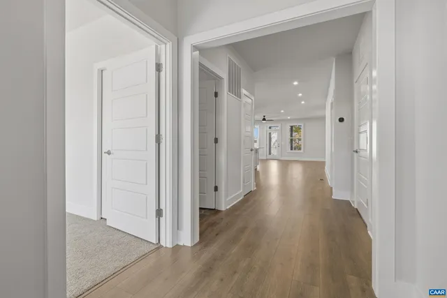 a view of a hallway with wooden floor