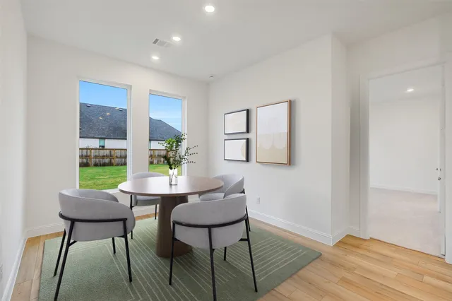 a dining room with furniture and window