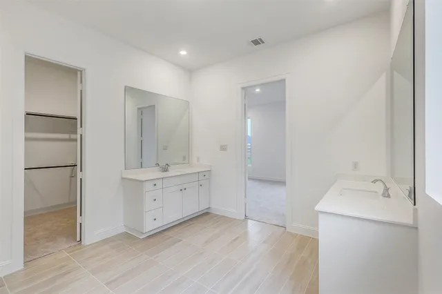 a bathroom with a sink a mirror and a shower
