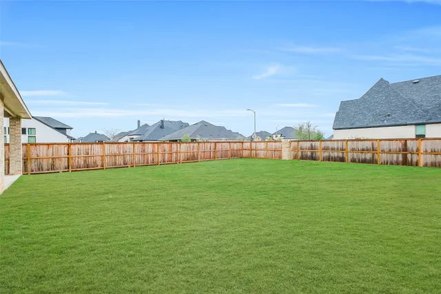 a view of a garden with a building in the background