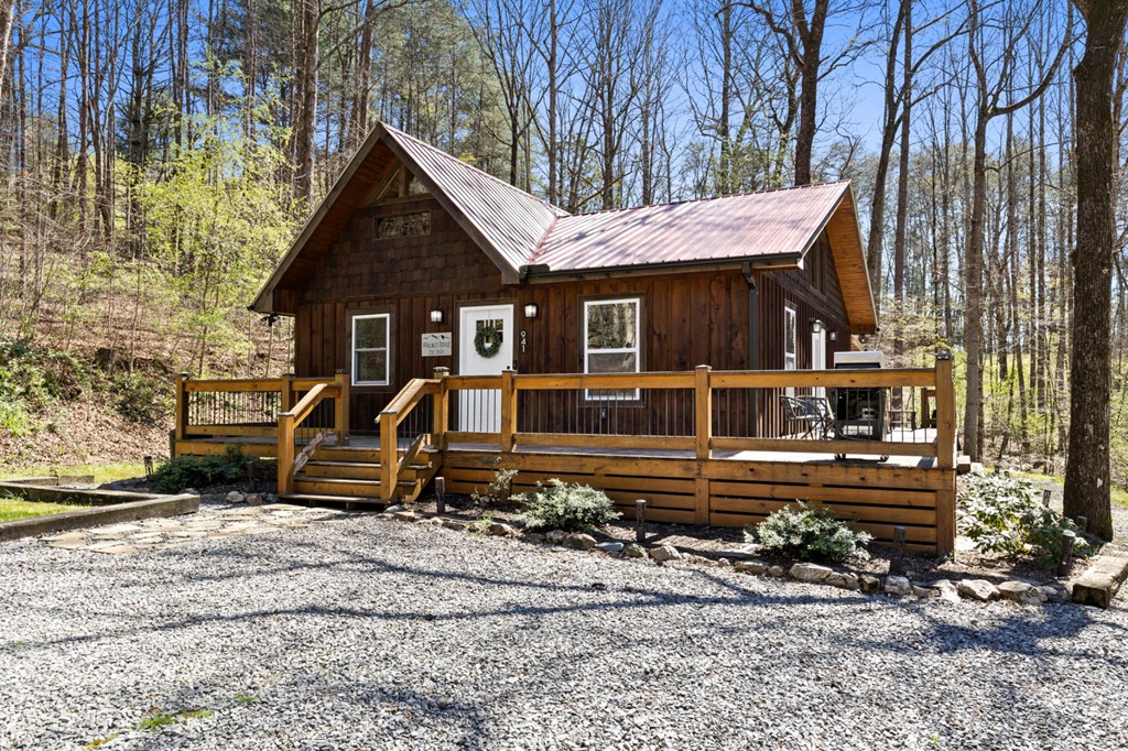 941 Hidden Valley Drive Morganton, GA 30560 - Photo 2 of 35 front view of a house with a bench