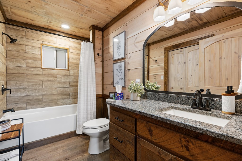 941 Hidden Valley Drive Morganton, GA 30560 - Photo 21 of 35 a bathroom with a granite countertop sink toilet mirror and bathtub